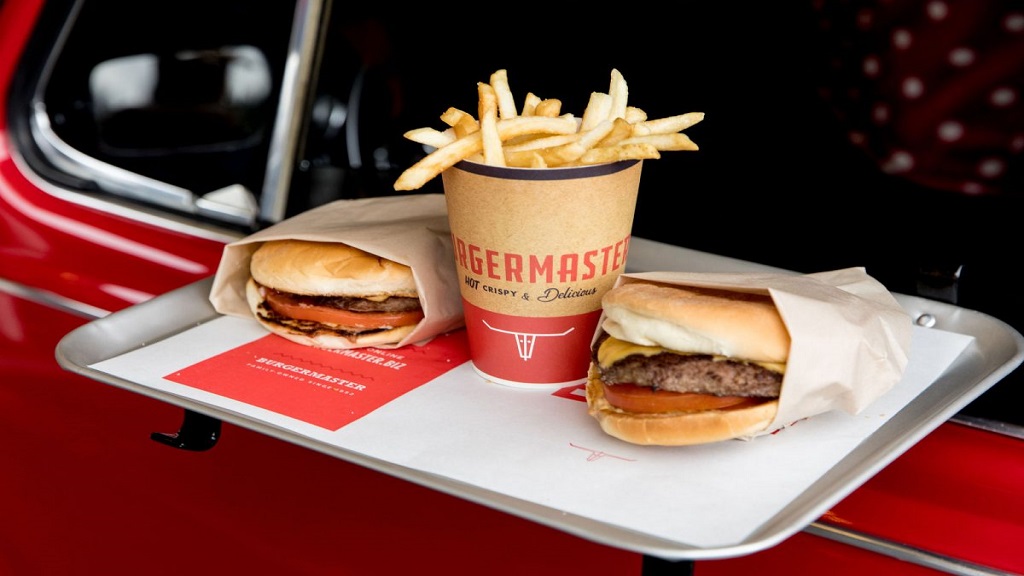 Image of a Burgermaster meal order on a tray attached to a car window. 