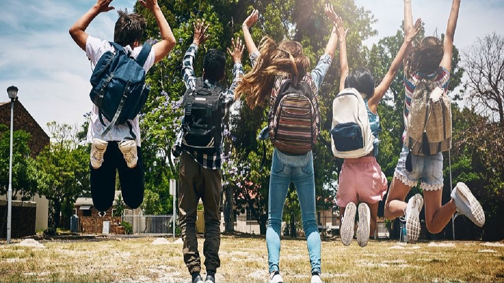 Image of kids jumping for joy outside the school playground.