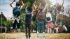 Image of kids jumping for joy outside the school playground.