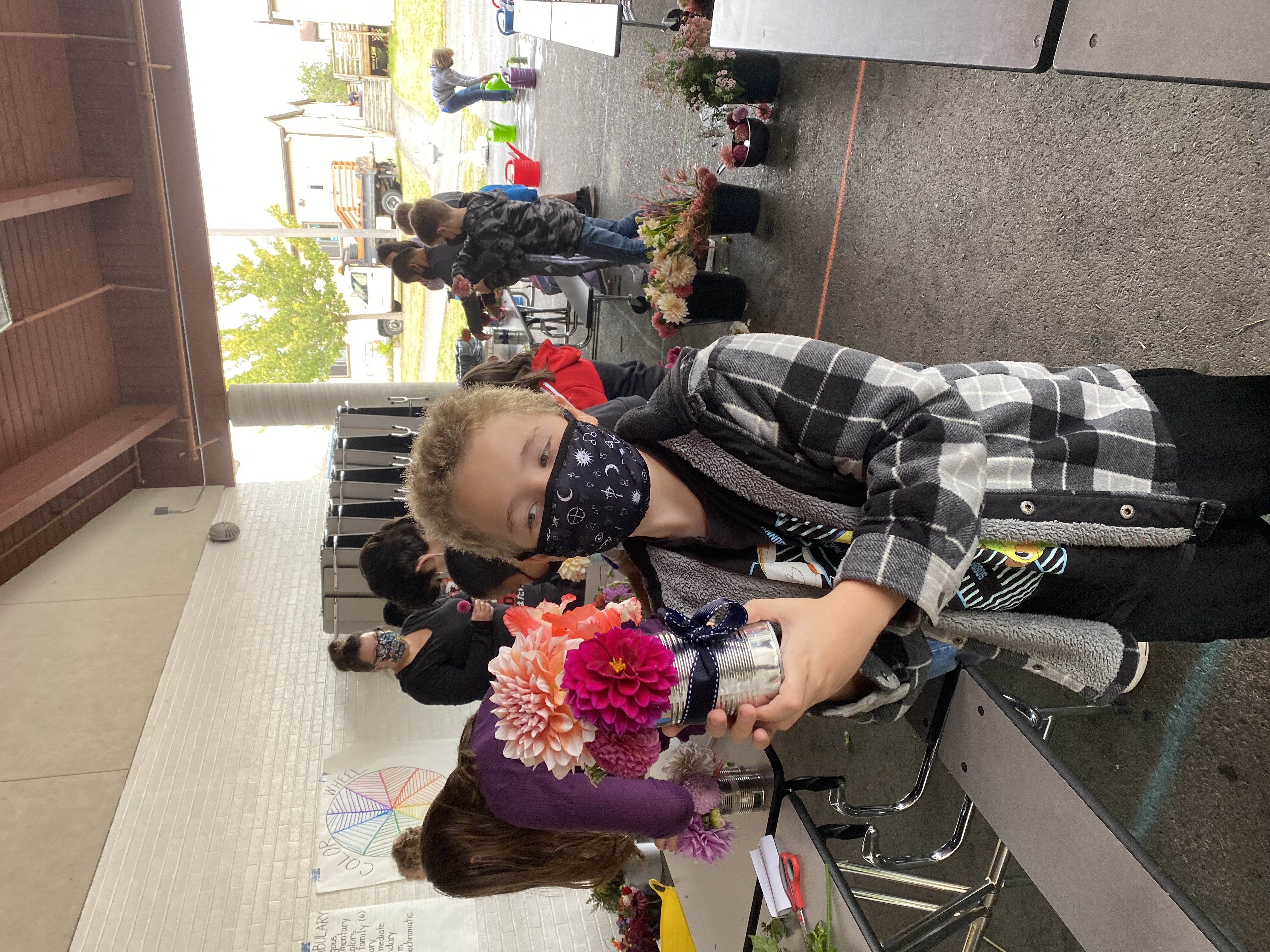 Student showing off his flower arrangement.