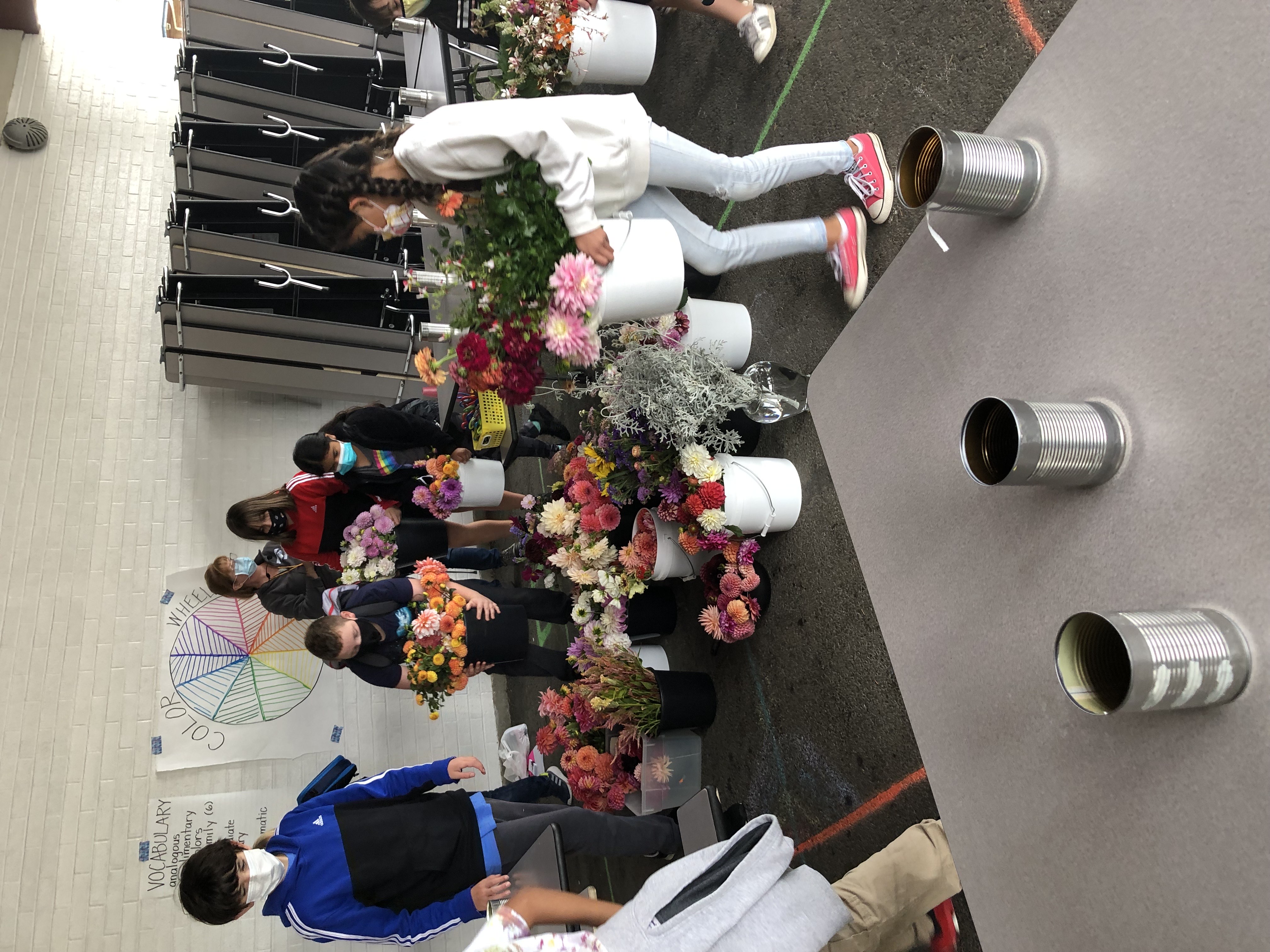 Students organizing supplies to work on flower arrangements.