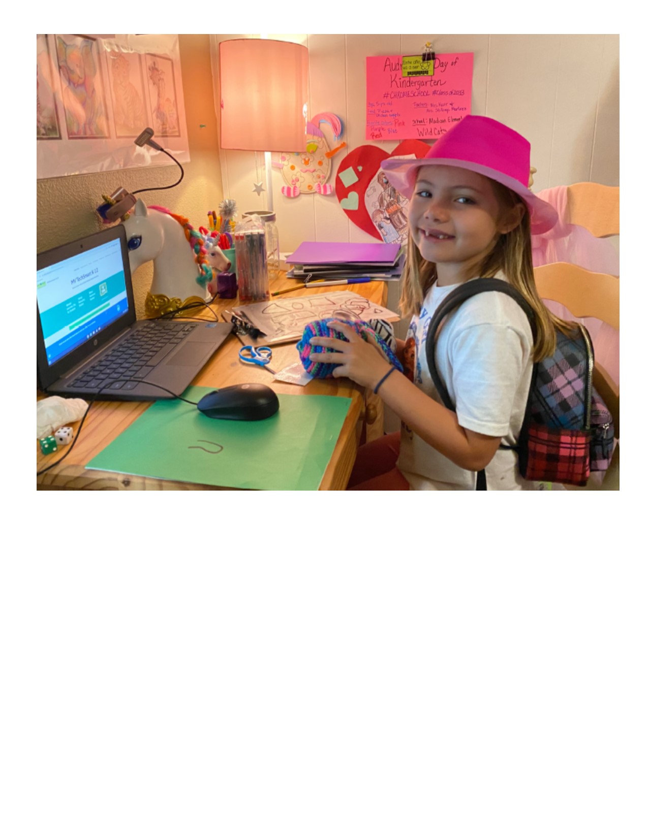 Image of a student in front of laptop learning from home.