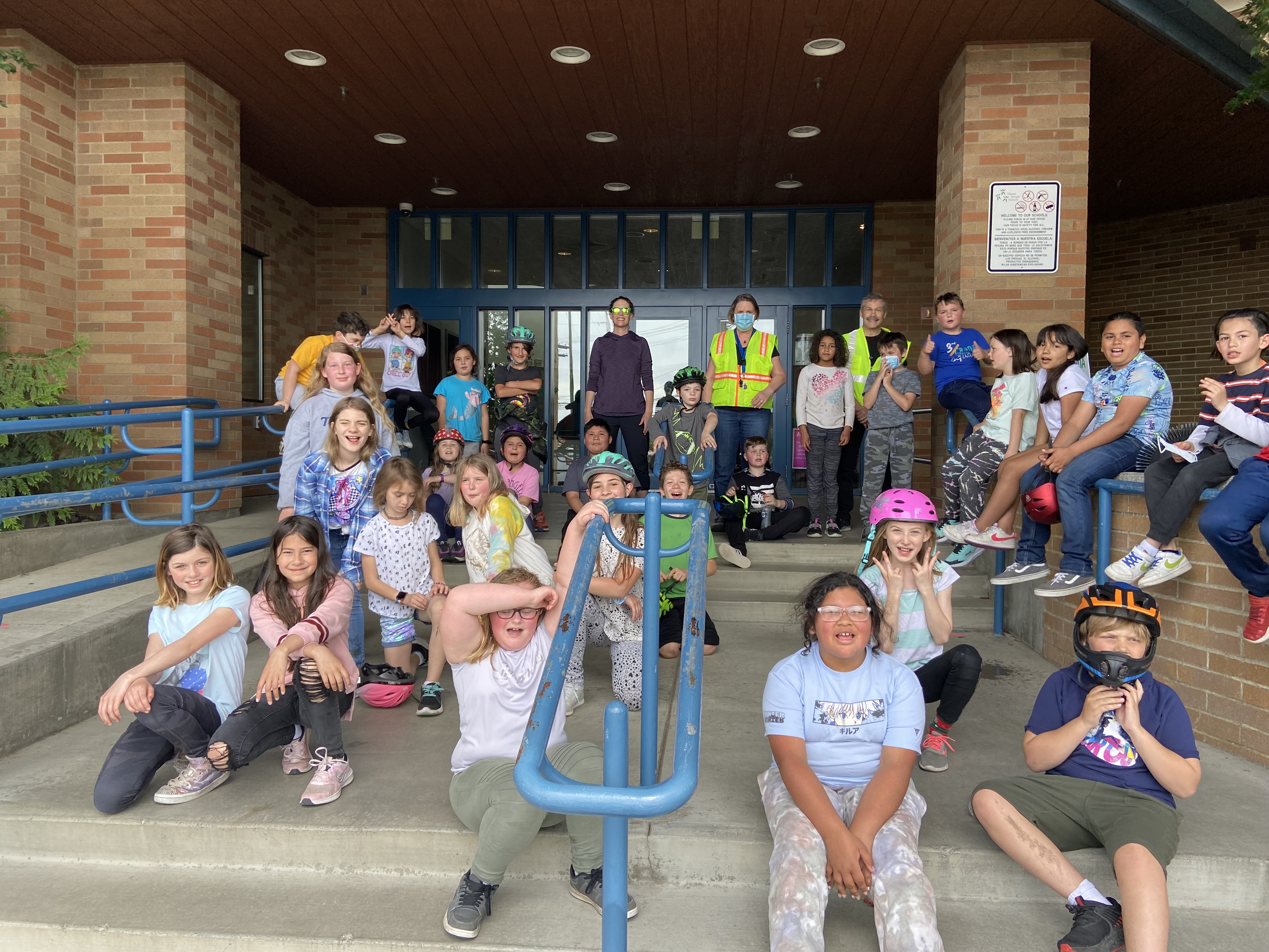 Group picture of Bike Club members on the steps of the school entrance.