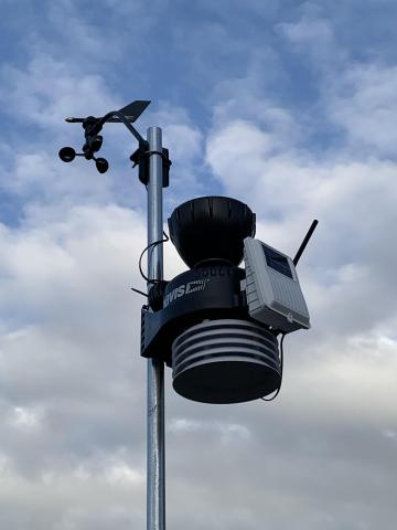Image of a weather station set up on a pole.