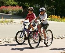 Picture of a boy and a girl riding their bikes.